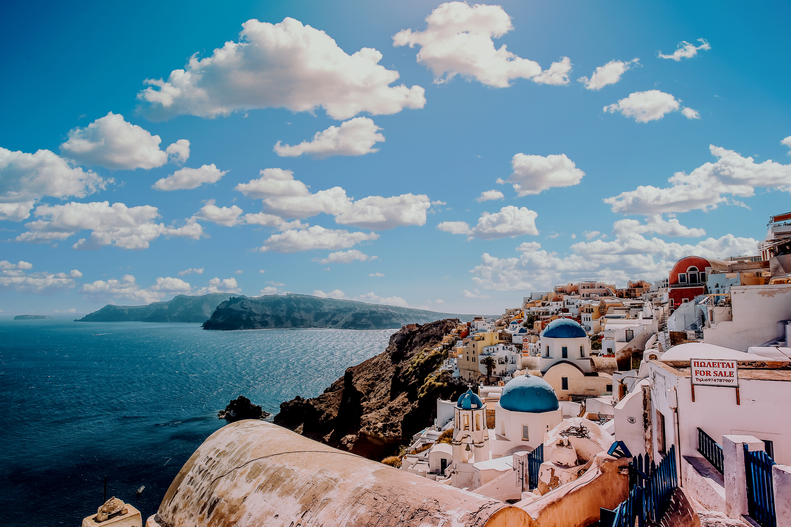 White Concrete House Near Body of Water Under White and Blue Cloudy Sky